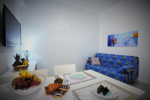 a living room with a table with a bowl of fruit at Central Apartments in Crotone