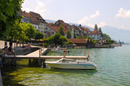 a boat in the water next to a dock at Executive suite in Zug Old Town Triplex in Zug
