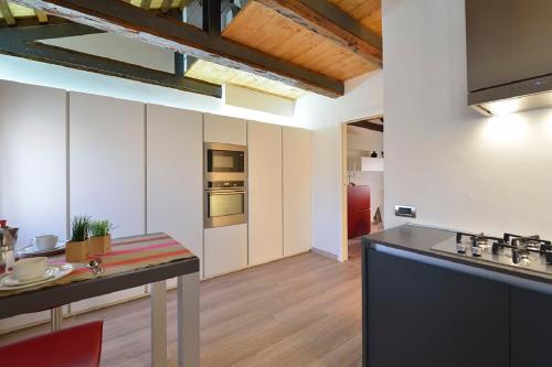 a kitchen with a counter top and a kitchen island at Sea to Sky Apartments by Wonderful Italy in Venice