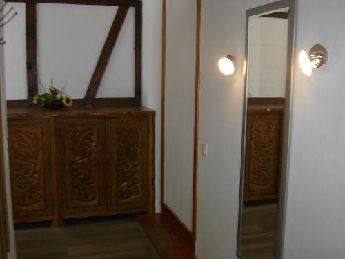 a room with a mirror and a wooden dresser at Gasthof Zum Stausee in Engelskirchen