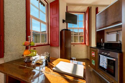a kitchen with a wooden counter top in a room at Flores Lofts in Porto