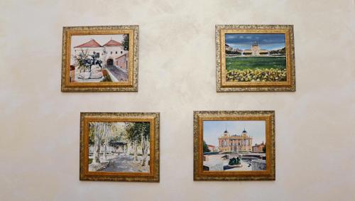 a group of four pictures hanging on a wall at Apartments & Rooms Flowers in Zagreb