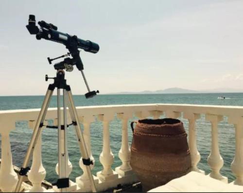 a camera on a tripod next to the ocean at Villa Rena In Front of the Sea in Arkoudi