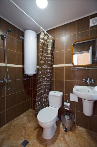 a bathroom with a toilet and a sink at Di Mare Holiday Village in Kranevo