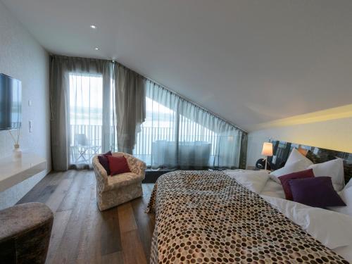 a hotel room with a leopard bed and a chair at Hotel-Restaurant-Schifflände in Birrwil