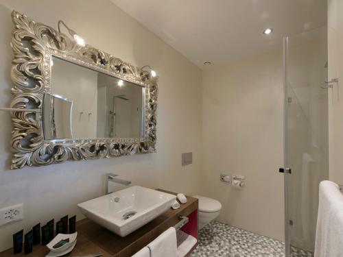 a bathroom with a sink and a mirror at Hotel-Restaurant-Schifflände in Birrwil