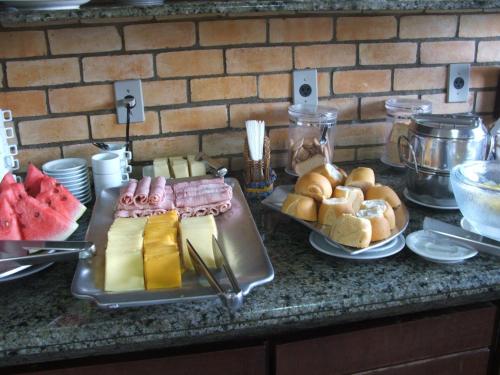 a table with a tray of food on a counter at Pousada da Ladeira in Pipa