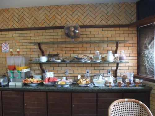 a counter with a bunch of food on it at Pousada da Ladeira in Pipa