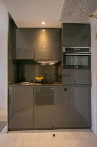 a kitchen with stainless steel appliances with a bowl of fruit at Grafton Street Studios by City Break Apartments in Dublin