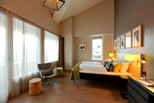 a bedroom with a bed and a desk with a chair at Myrkdalen Resort Hotel in Myrkdalen