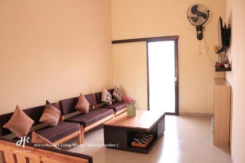 a living room with a couch and a table at dric's House in Tanjungpandan