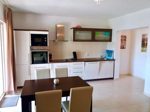 a kitchen with a table and chairs in a room at Villa Skoric in Orebić