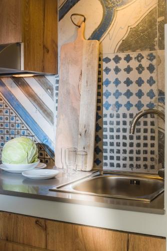 a kitchen with a sink and a counter top at Natali Apartments by Estia in Malia