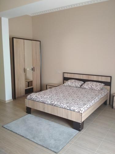 a bedroom with a bed and a mirror at Hotel Elita in Odesa