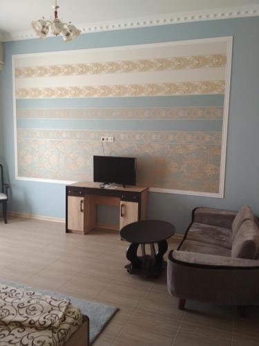 a living room with a desk and a couch at Hotel Elita in Odesa