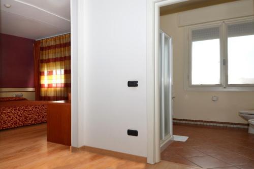 Ένα ή περισσότερα κρεβάτια σε δωμάτιο στο Hotel Eolo