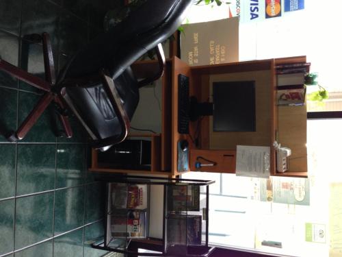 a kitchen with a microwave and a tv on a wall at Bay City Inn in Bellingham