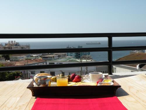 a tray of breakfast food on a table on a balcony at B&B Hostel CasaMoro in Viña del Mar