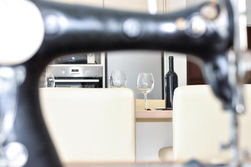 a counter with two wine glasses and a bottle of wine at Solymar in Posedarje