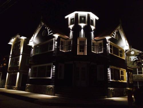 a large house with lights on it at night at Paseo Piedra Buena in San Martín de los Andes