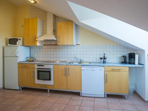 a kitchen with a sink and a stove at An der Pappelwende in Ostseebad Karlshagen