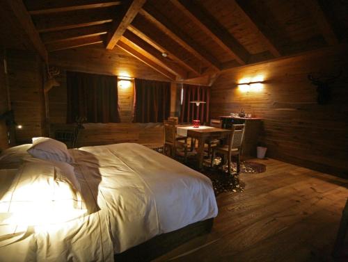 a bedroom with a bed and a table in it at Locanda Sensi in Rivergaro