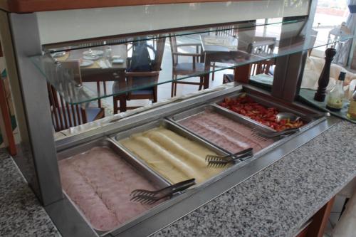 a kitchen with a counter with some food at Hotel Nike in Giardini Naxos