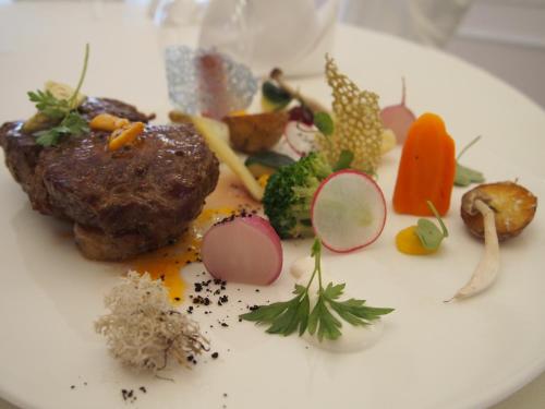 a plate of food with meat and vegetables on it at Dworek Hetmanski in Stargard