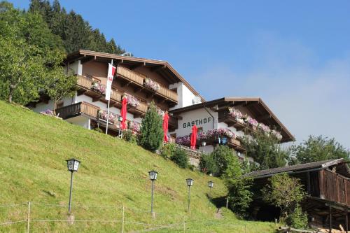a hotel on the side of a hill at Gasthof Pension Berghof in Hippach