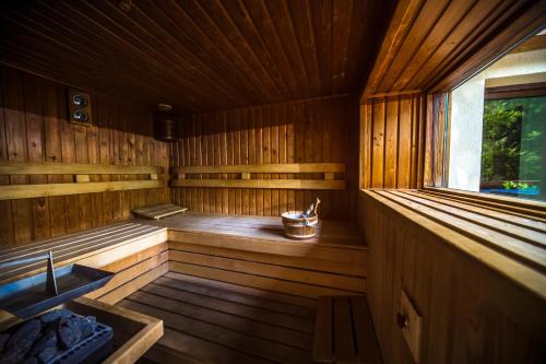 an empty wooden sauna with a window in it at Patak Park Hotel Visegrád in Visegrád