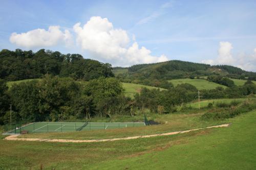 a tennis court in the middle of a field at Sid Valley Country House Hotel in Sidmouth