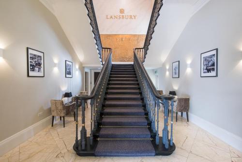 eine Treppe in einem Haus mit Treppenaufgang in der Unterkunft Lansbury Heritage Hotel in London