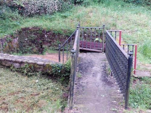 a gate with a dog sitting on a bench at Posada Montero de la Concha in Esles