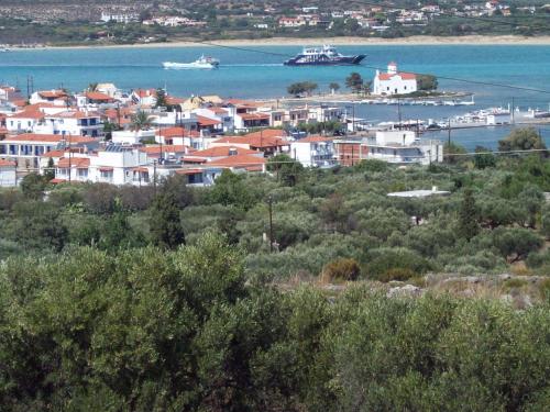 a town with a harbor and boats in the water at The Captain in Elafonisos