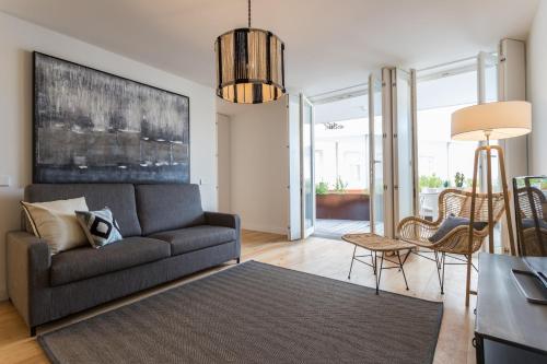 a living room with a couch and a table at FLH Martim Moniz Terrace Flat in Lisbon