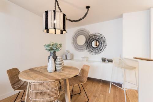 a dining room with a table and chairs and a mirror at FLH Martim Moniz Terrace Flat in Lisbon