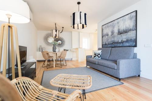 a living room with a couch and a table at FLH Martim Moniz Terrace Flat in Lisbon