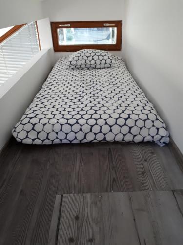 a bed in the corner of a room at Spa Cottage in Čatež ob Savi