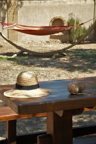 a hat sitting on top of a wooden table at LIORIZA Country Houses in Kalamaki