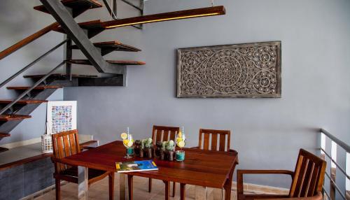 a dining room with a wooden table and chairs at Casa Tortuga in Morro del Jable