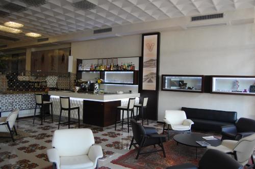 a bar in a lobby with chairs and a counter at Grand Hotel Moroni in Finale Ligure