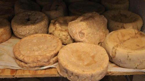 a bunch of different types of donuts on a shelf at Quinta da Cerdeira in Seia