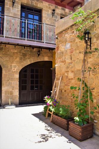 a building with a wooden door and a wooden bench at S.Nikolis' Historic Boutique Hotel in Rhodes Town