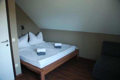 a bed with white sheets and pillows in a room at Ferienwohnung Sommeregger in Leutschach