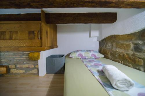 a small room with a bed in a building at Traditional Piran studio in Piran