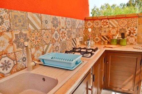 a kitchen with a sink and a stove at Campeggio Sanfilippo in Cefalù