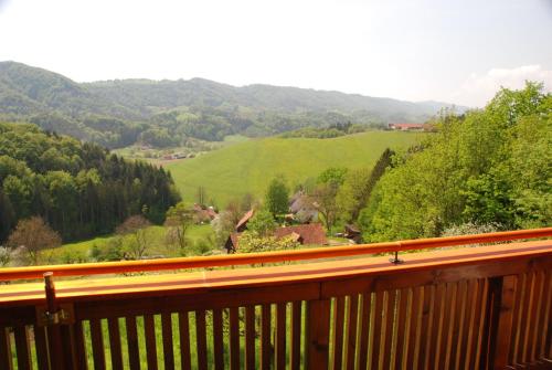 a wooden balcony with a view of a valley at Ferienwohnung Sommeregger in Leutschach