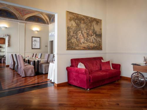 a living room with a red couch and a table at HNN Luxury Suites in Genova