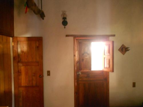 a room with a wooden door and a window at Cabañas los Venados in Mazamitla