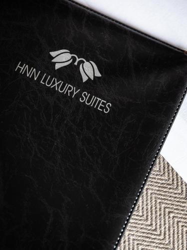 a black leather wallet with a logo on it at HNN Luxury Suites in Genova